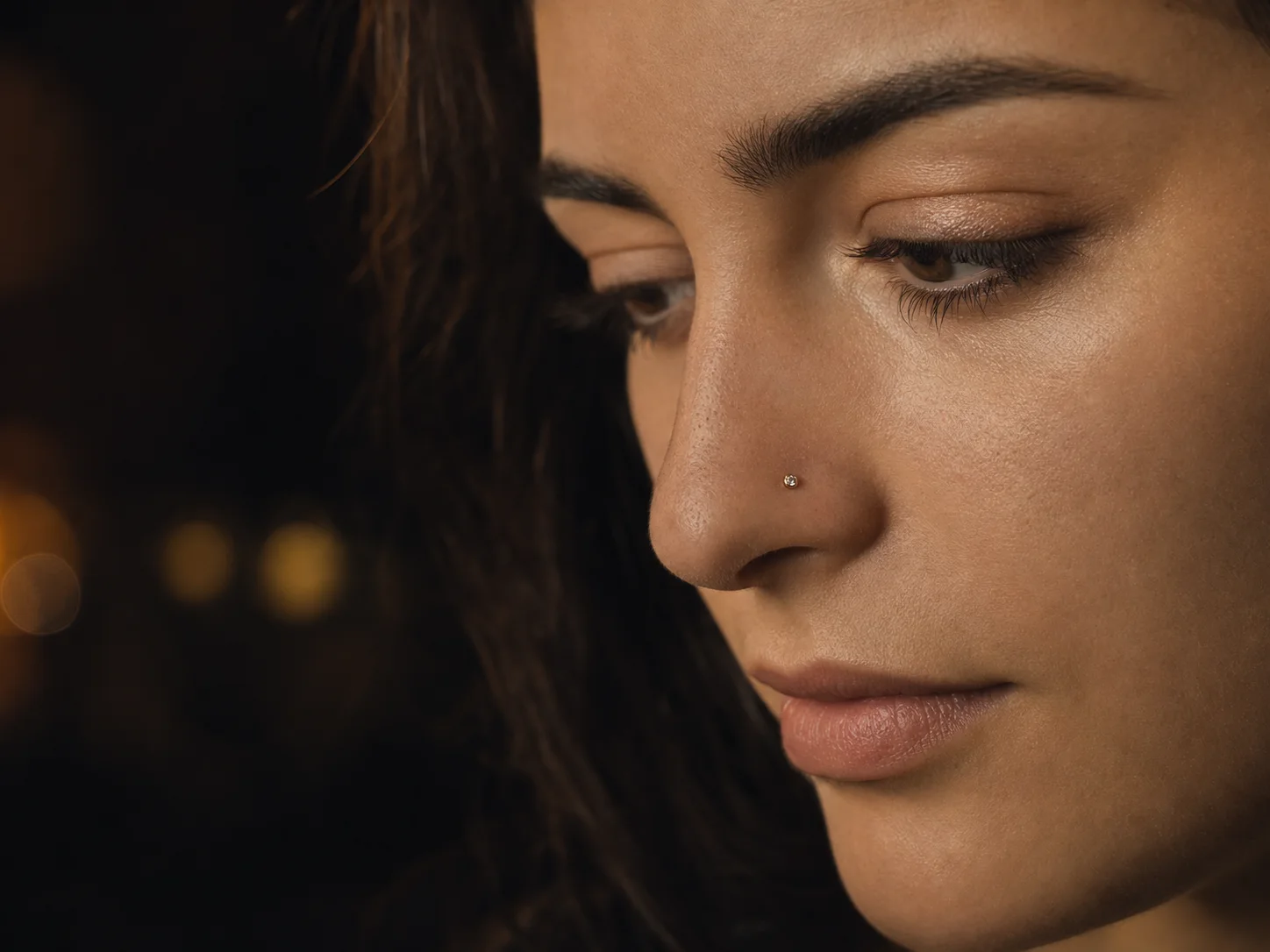 Warm gem detail — original nose piercing jewelry direction photographed for Chill Ink