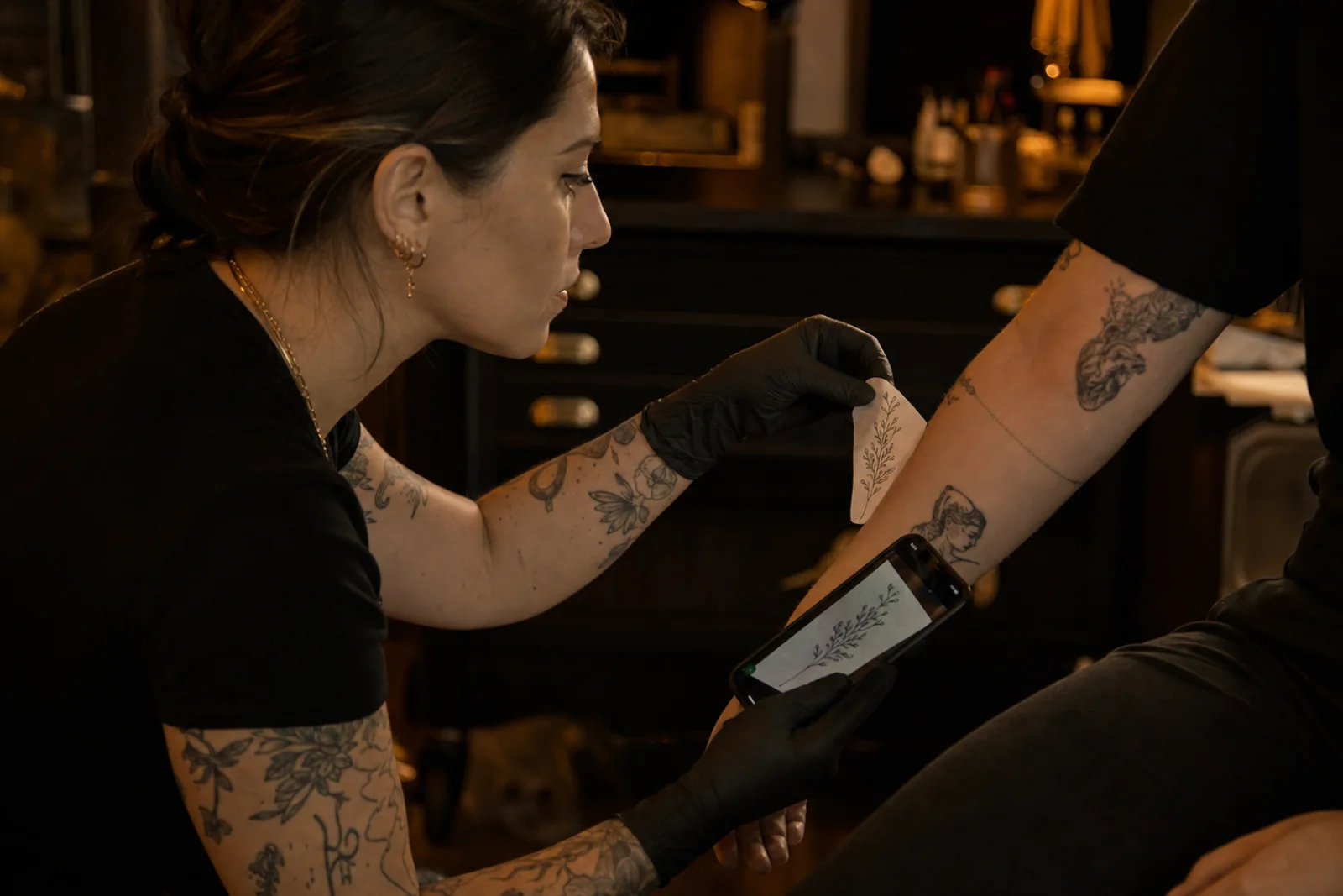 Female Chill Ink artist discussing a tattoo idea with a client in Galata
